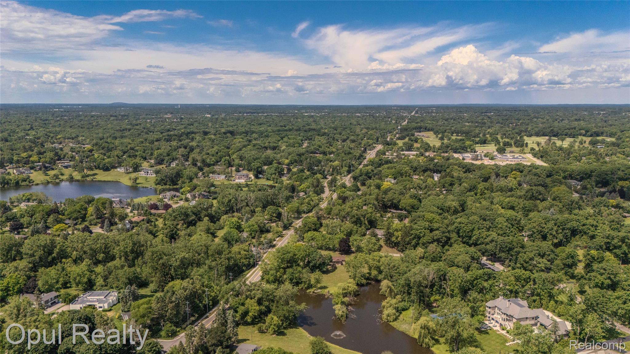 6455 Norham Road Bloomfield Hills, MI 48301 - Photo 78 of 93 Expansive aerial landscape showcasing a verdant tree canopy across a residential area