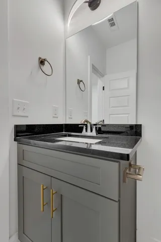 a sink a mirror and vanity