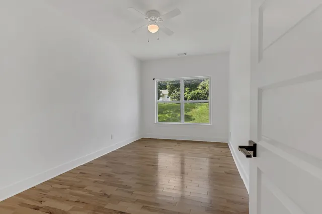 wooden floor in an empty room with a window