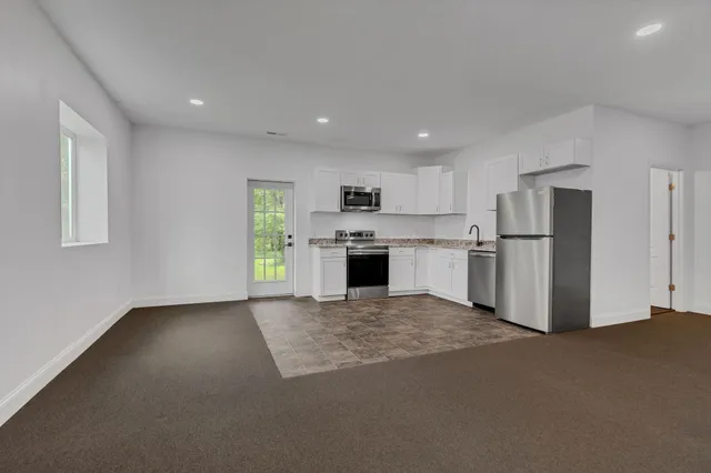 a view of a kitchen with a sink stove and a refrigerator