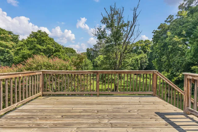 a view of backyard with a deck