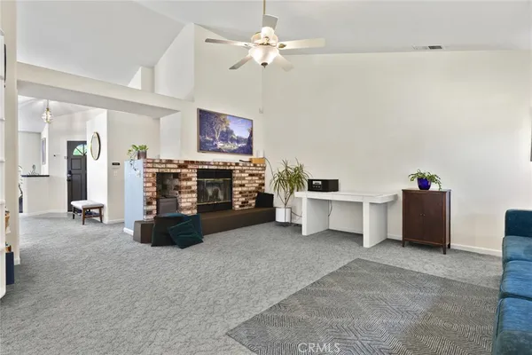 a view of a livingroom with furniture and a ceiling fan