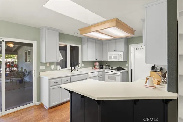 a kitchen with a sink a stove and cabinets