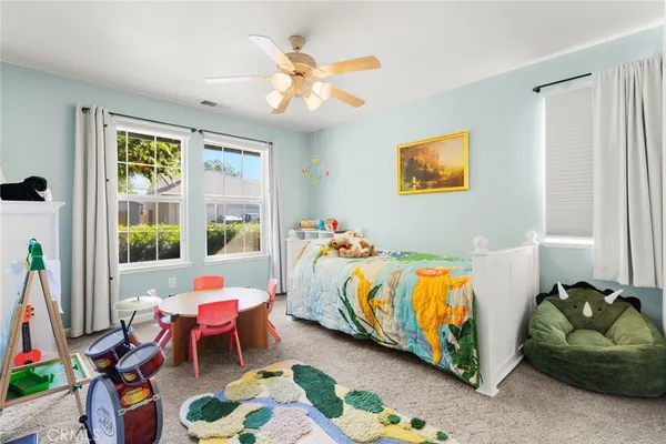 a bed room with a bed and a chair