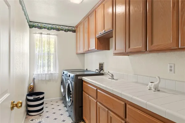 a kitchen with sink cabinets and stove