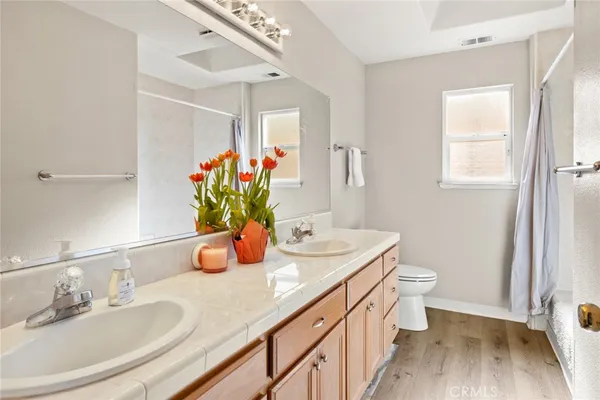 a bathroom with a double vanity sink and a mirror