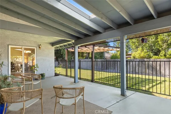 a view of a porch with furniture and backyard