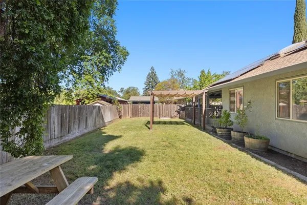 a backyard of a house with table and chairs