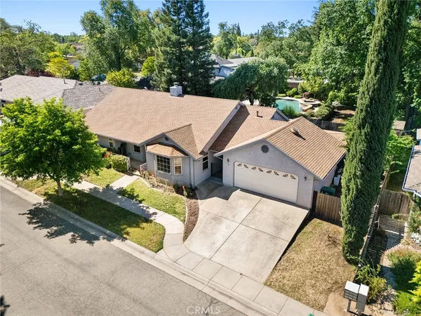 an aerial view of a house with a yard