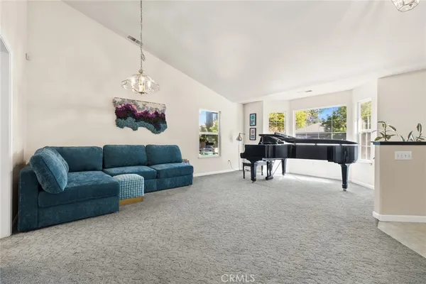 a living room with furniture and a chandelier