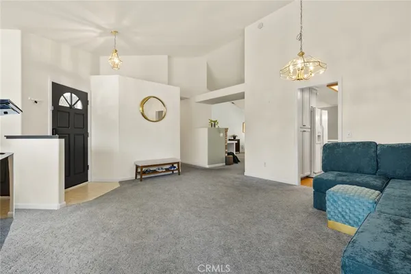 a view of a livingroom with furniture and a chandelier
