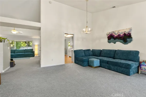 a living room with furniture and a chandelier