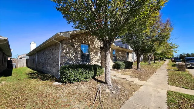 a view of a pathway of a house with a yard