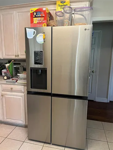 a kitchen with stainless steel appliances a refrigerator sink and microwave