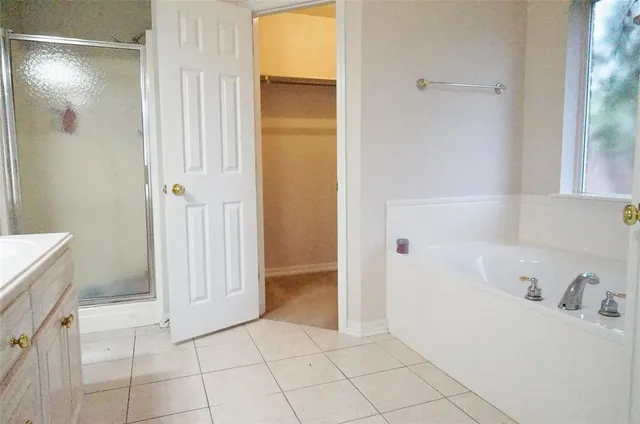 a bathroom with a bathtub and sink