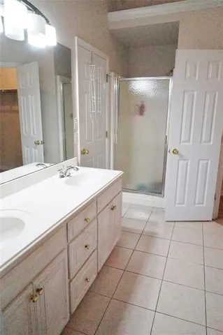 a bathroom with a sink a mirror and a shower