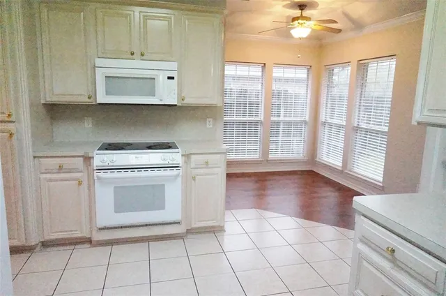 a kitchen with stainless steel appliances a stove top oven and cabinets