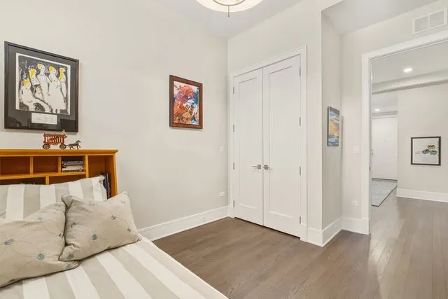 a bedroom with a bed and a book shelf