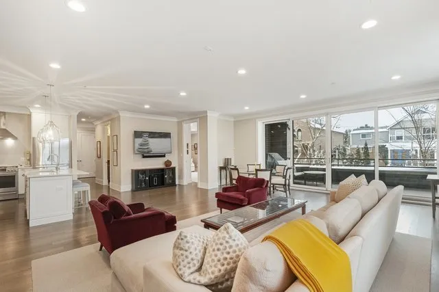a living room with furniture wooden floor and a fireplace