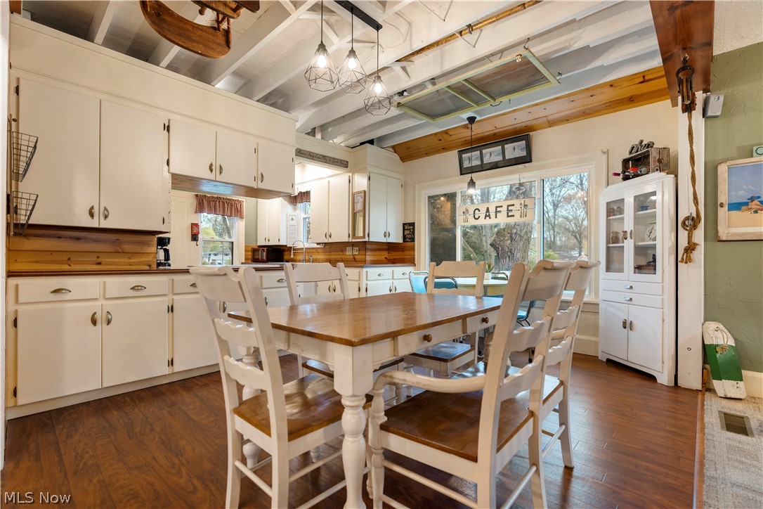 120 34th Street Southwest Canton, OH 44706 - Photo 7 of 30 Dining area with dark hardwood / wood-style flooring, beam ceiling, and a chandelier