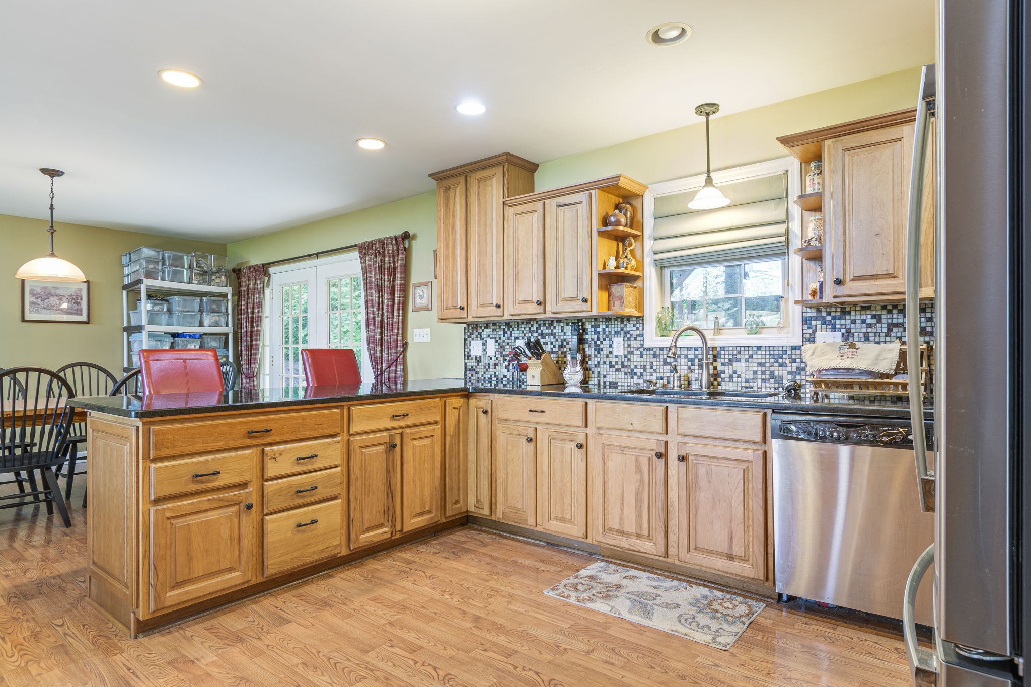 300 Gunter Smith Road Pulaski, TN 38478 - Photo 27 of 66 a large kitchen with kitchen island granite countertop a stove a sink and dishwasher wooden cabinets with granite countertops