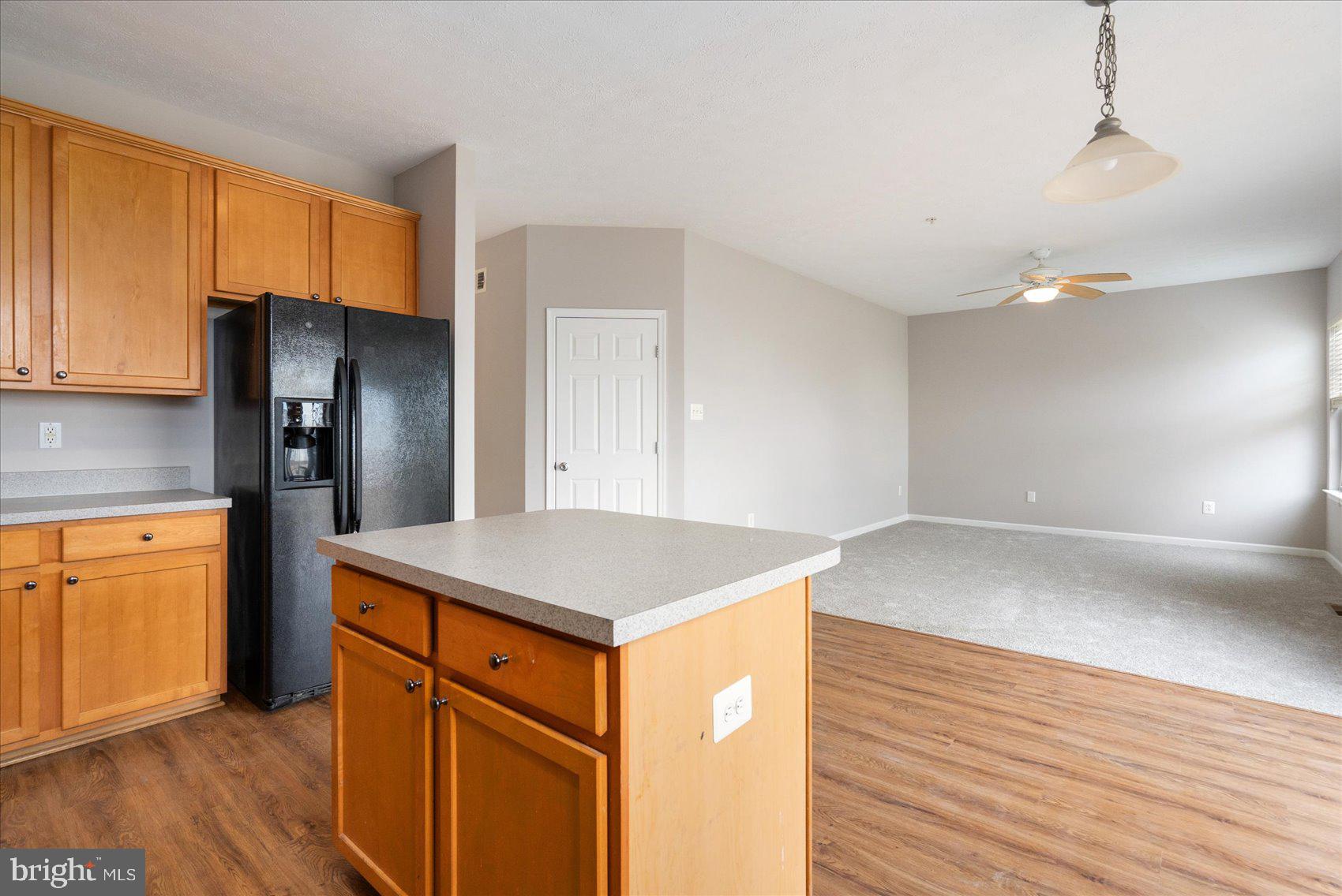 615 Tinker Road Middle River, MD 21220 - Photo 17 of 50 a kitchen with stainless steel appliances granite countertop a refrigerator a sink dishwasher and wooden cabinets with wooden floor