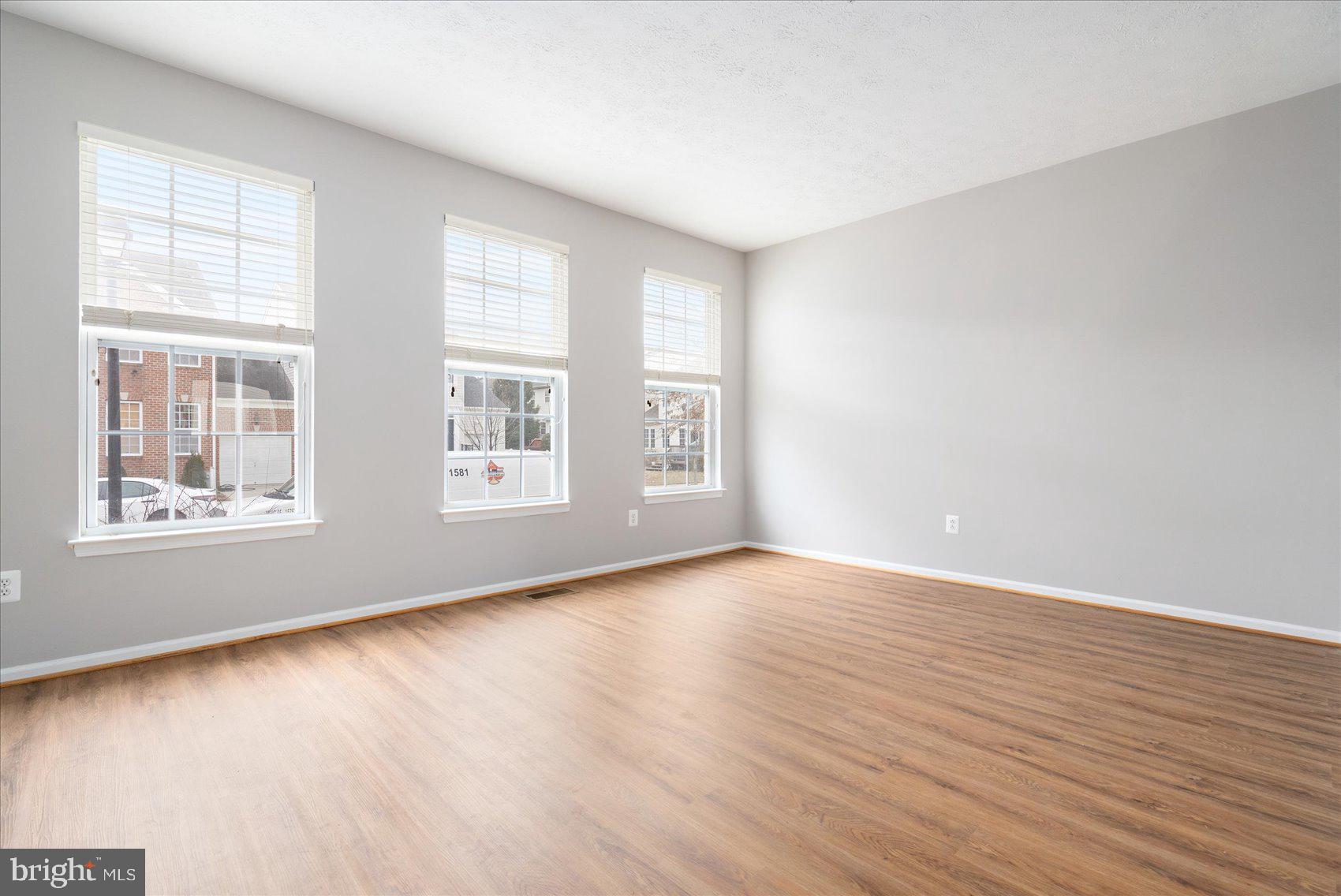615 Tinker Road Middle River, MD 21220 - Photo 6 of 50 a view of an empty room with wooden floor and a window