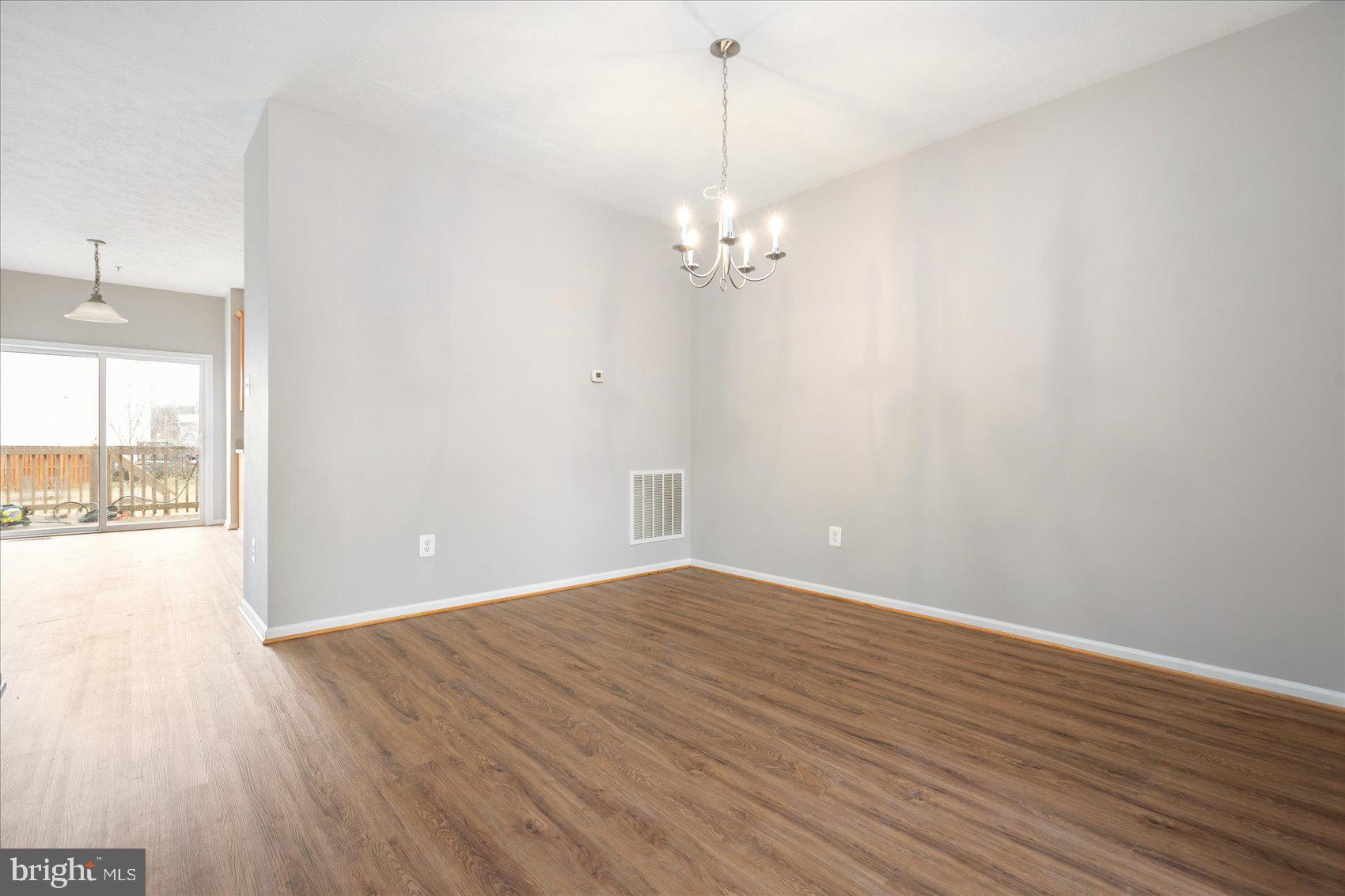 615 Tinker Road Middle River, MD 21220 - Photo 9 of 50 an empty room with wooden floor and windows