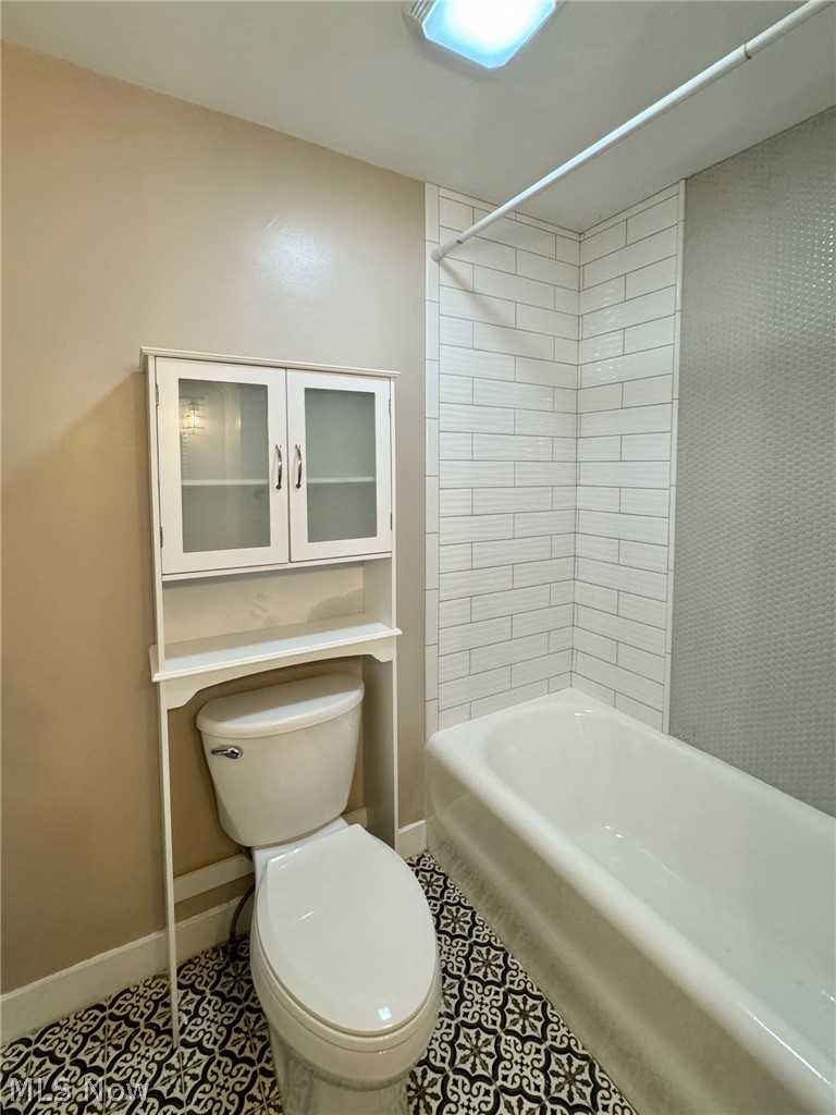 507 Canton Road Wintersville, OH 43953 - Photo 36 of 45 Bathroom featuring shower combination, toilet, and tile flooring
