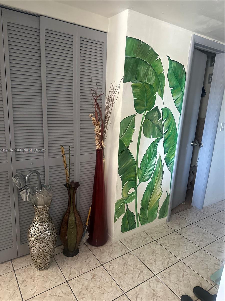 1400 Northeast 169th Street, Unit 215 Miami, FL 33162 - Photo 11 of 13 a view of a potted plant in front of a window