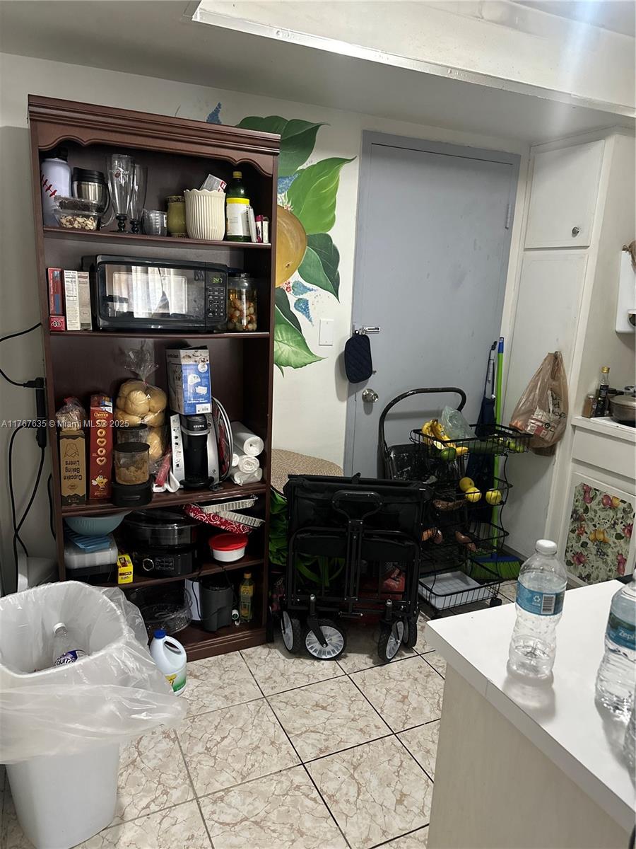 1400 Northeast 169th Street, Unit 215 Miami, FL 33162 - Photo 3 of 13 a room with furniture and book shelf