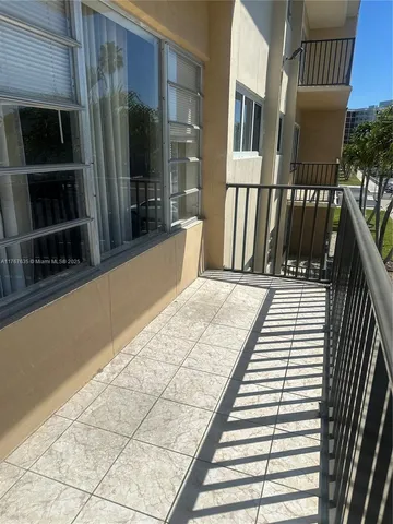 a bedroom with a bed wooden floor and window