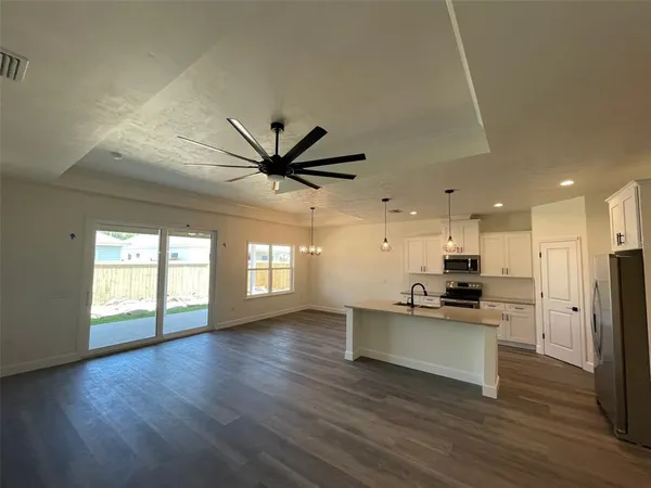 a view of a kitchen with a sink and a window