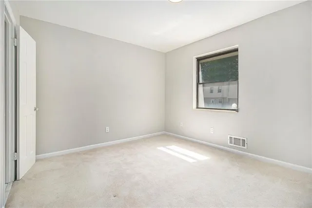 a bathroom with a granite countertop sink a toilet and shower