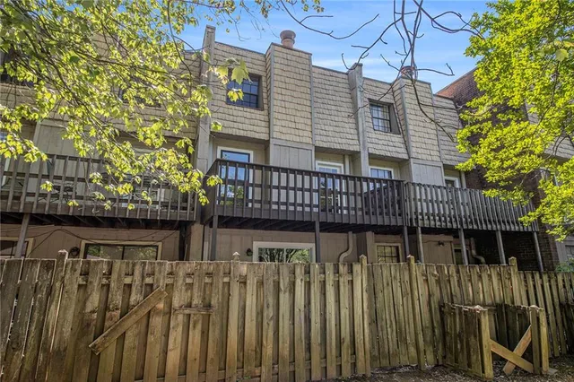 a balcony with wooden floor and fence