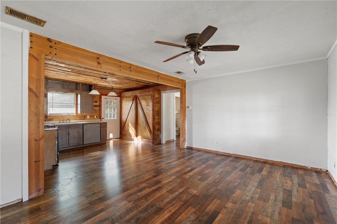 117 South Judge R W Hailey Drive Lott, TX 76656 - Photo 2 of 16 a view of empty room with wooden floor and windows