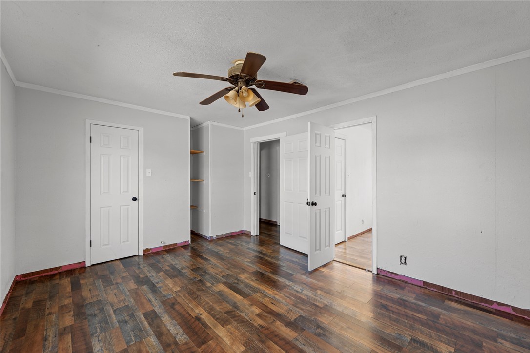 117 South Judge R W Hailey Drive Lott, TX 76656 - Photo 7 of 16 a view of room with wooden floor and ceiling fan