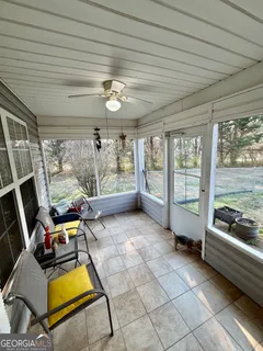 a room with gym equipment and large windows