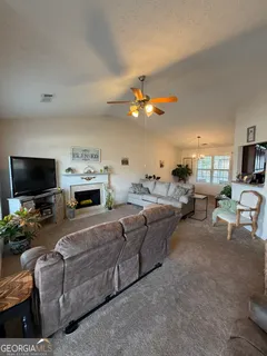 a living room with furniture and a flat screen tv