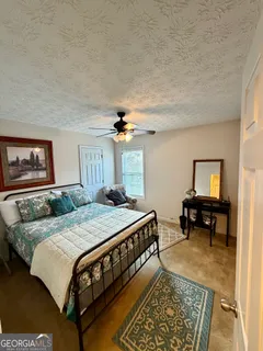 a bedroom with a bed a table and chair