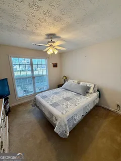 a bed sitting in a room next to a window