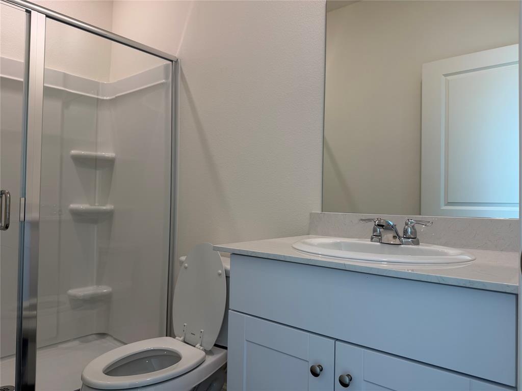 609 Merced River Lane Anna, TX 75409 - Photo 12 of 27 a bathroom with a sink a toilet and shower