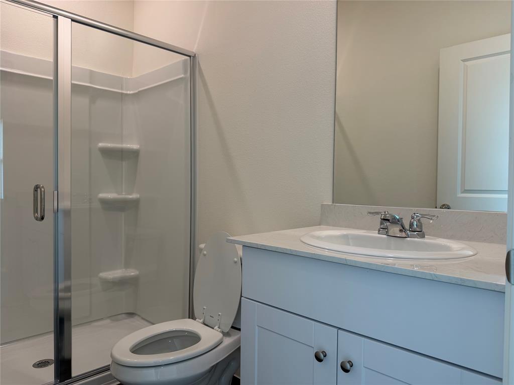 609 Merced River Lane Anna, TX 75409 - Photo 13 of 27 a bathroom with a sink a toilet and shower