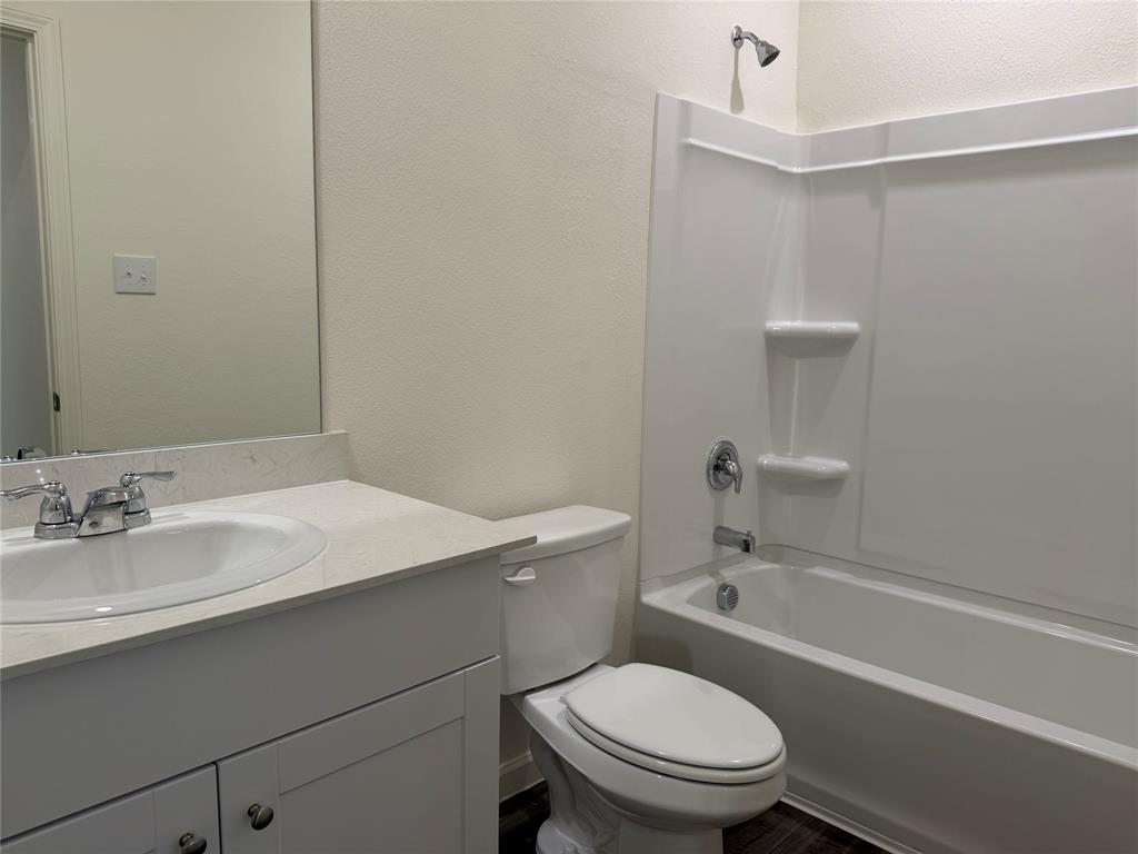 609 Merced River Lane Anna, TX 75409 - Photo 21 of 27 a bathroom with a sink a toilet and shower