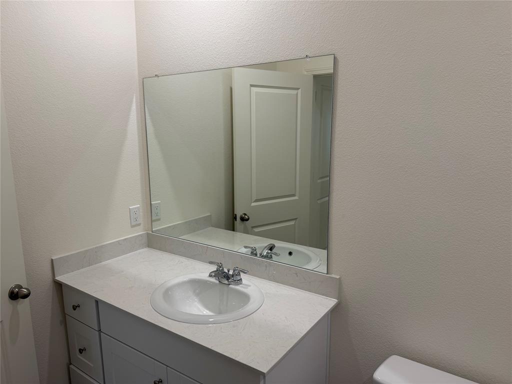 609 Merced River Lane Anna, TX 75409 - Photo 22 of 27 a bathroom with a sink and a mirror