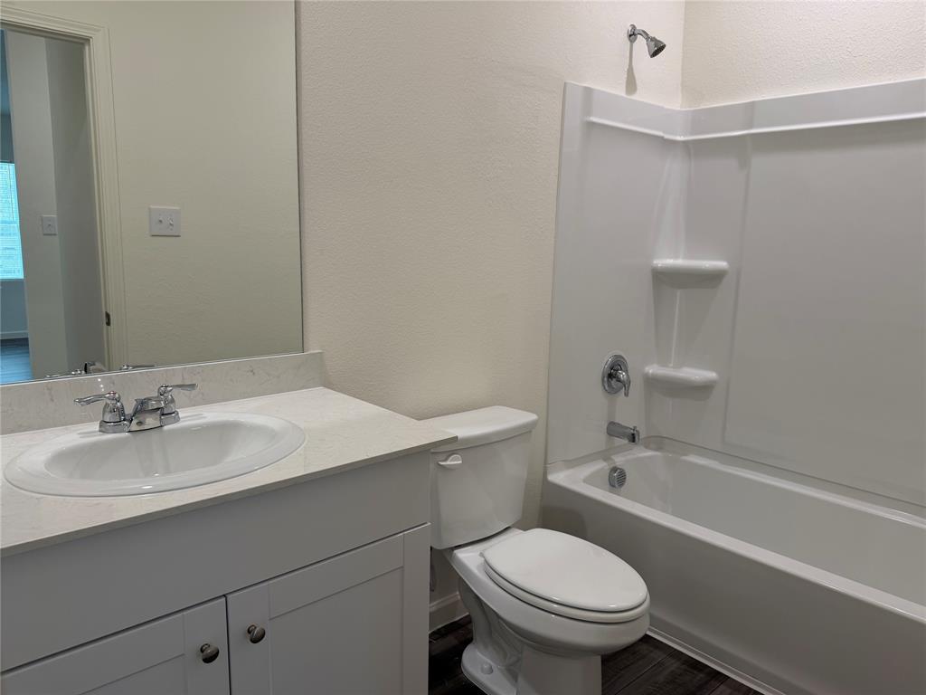 609 Merced River Lane Anna, TX 75409 - Photo 24 of 27 a bathroom with a sink a toilet and shower