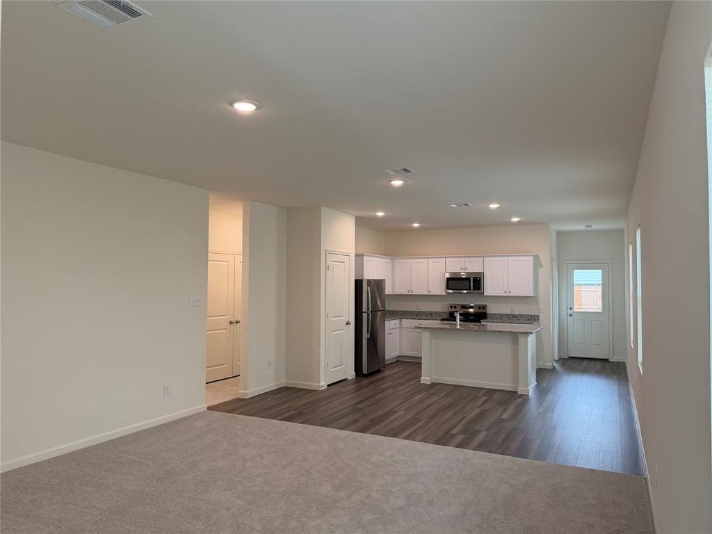 609 Merced River Lane Anna, TX 75409 - Photo 3 of 27 a kitchen with a refrigerator and a sink