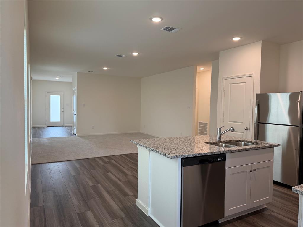 609 Merced River Lane Anna, TX 75409 - Photo 8 of 27 a kitchen with a sink and refrigerator