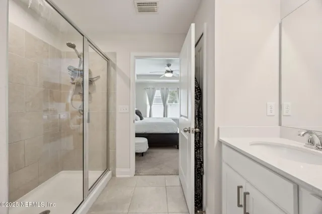 a en suite bathroom with a granite countertop sink a toilet and shower