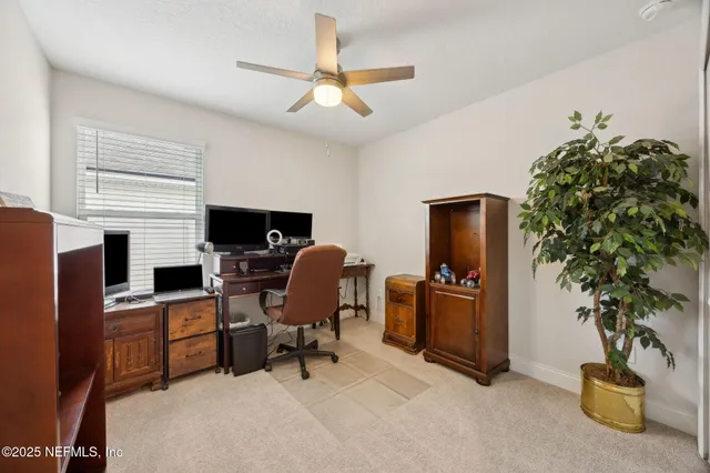 a view of a workspace with furniture and a potted plant